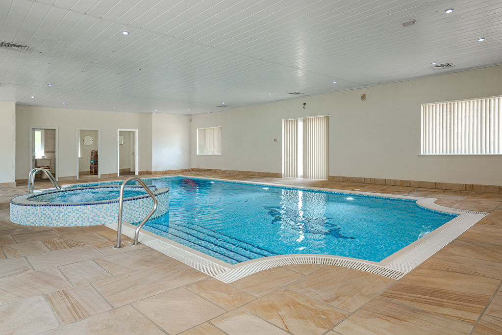Indoor swimming pool with adjoining spa pool at Birkdale